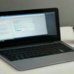 Minimalist home office workstation displaying remote data evaluation software on a screen in natural daylight.