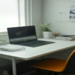 A modern laptop on an organized home desk displaying remote microtask workflow data.