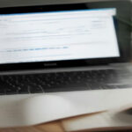 Modern desk setup with a laptop displaying research data, reflecting online reward and survey platform operations.