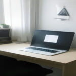 Laptop displaying an online account registration page on a clean wooden desk.