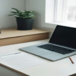 Clean desk with a laptop and notebook, representing digital account management and user privacy setup.