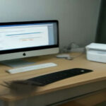 A modern laptop setup with a USB microphone arranged for user research and website testing work.