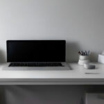 Minimalist home office setup with a computer screen and quiet testing equipment for digital research.