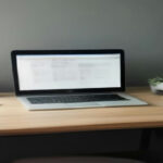 A modern workstation setup displaying study materials for an online AI annotation and writing assessment.