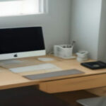 Home office workspace set up for virtual call center customer support work on a laptop.