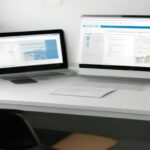 A digital content creator laptop desk setup showing newsletter publishing metrics and subscriber growth tools.