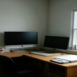 A minimalist writing setup with a laptop displaying a newsletter dashboard under daylight.