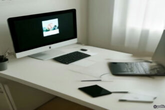 Minimalist workspace setup for an online tutor working on a laptop with study materials.
