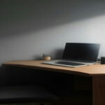 A remote working environment setup with a laptop displaying developer screening and project assessment metrics.