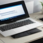 Digital artist workspace with graphic tablet displaying vector art and laptop open on wooden desk