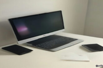 A smartphone displaying a mobile game resting on a modern clean wooden desk beside a notebook.