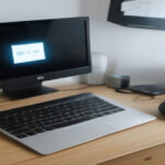 A modern home office setup with a computer displaying remote job application requirements.