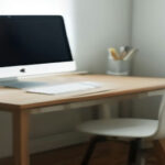 A modern home office setup with a laptop and workspace used for remote data evaluation work.