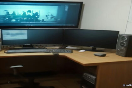 Video creator workstation showing video editing equipment and analytics on a screen.